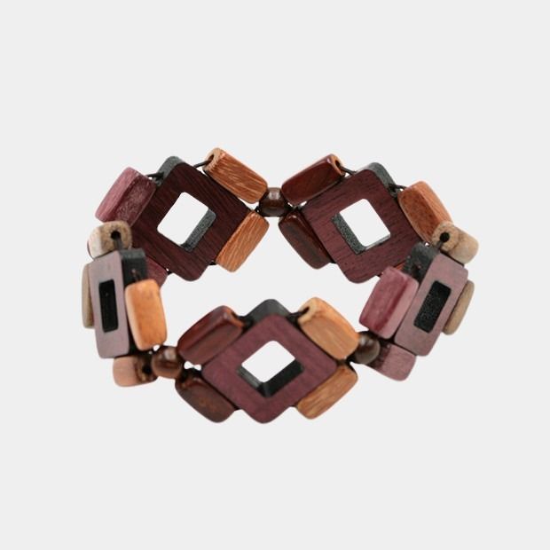 Bracelet Nofilia en bois multicolore avec perles d'amarante, palissandre, néflier et murier. Élégance et couleur sur un fond gris!