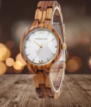 Un gros plan de la montre Vénissia en bois de zébrano, montrant son cadran blanc nacré et ses chiffres romains dorés.